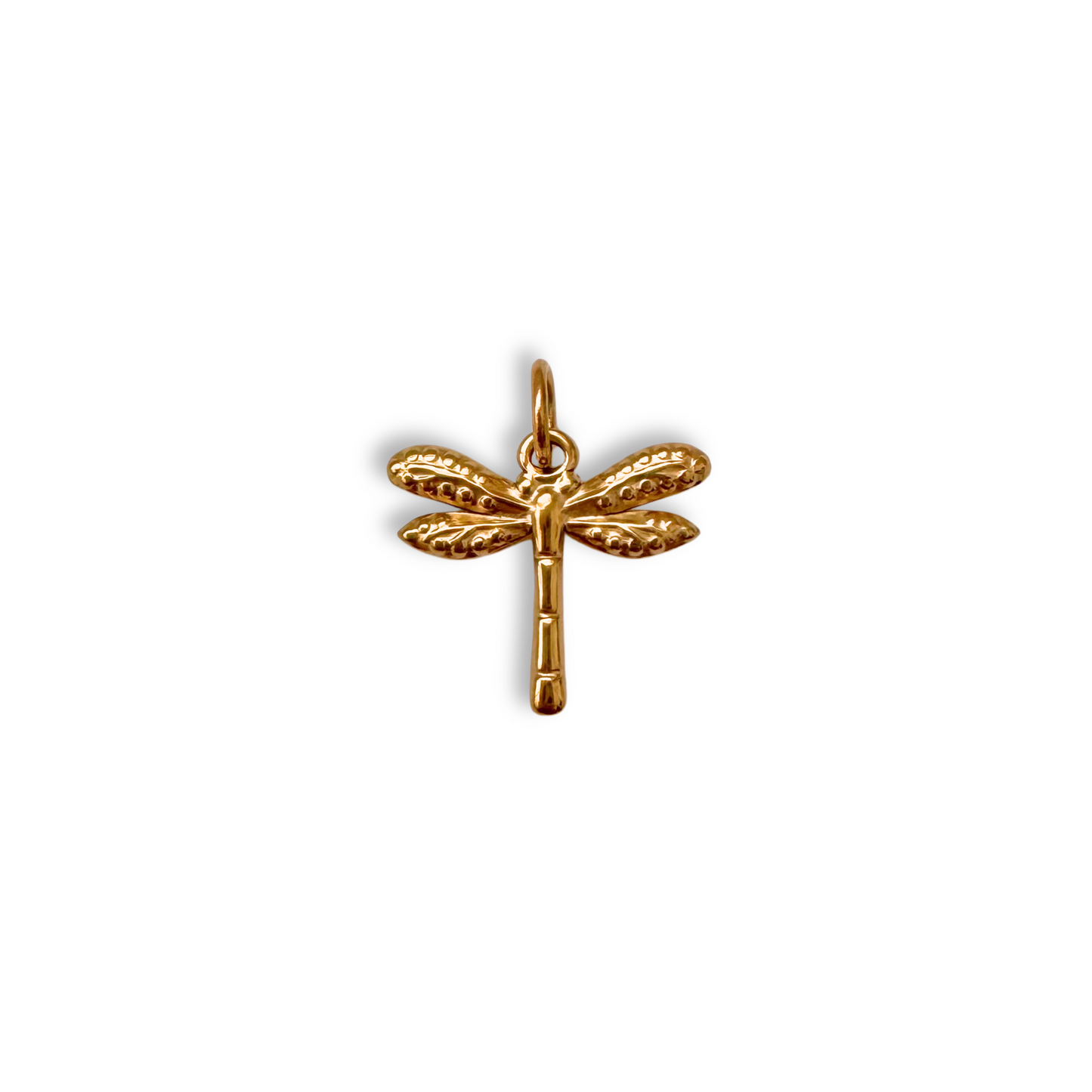 Gold dragonfly pendant on a white background