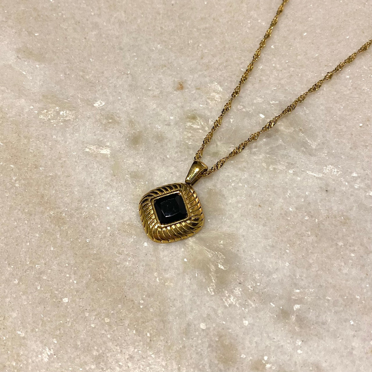 gold pendant necklace with black zircon