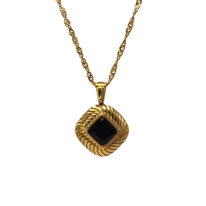 gold ribbed pendant with black zircon