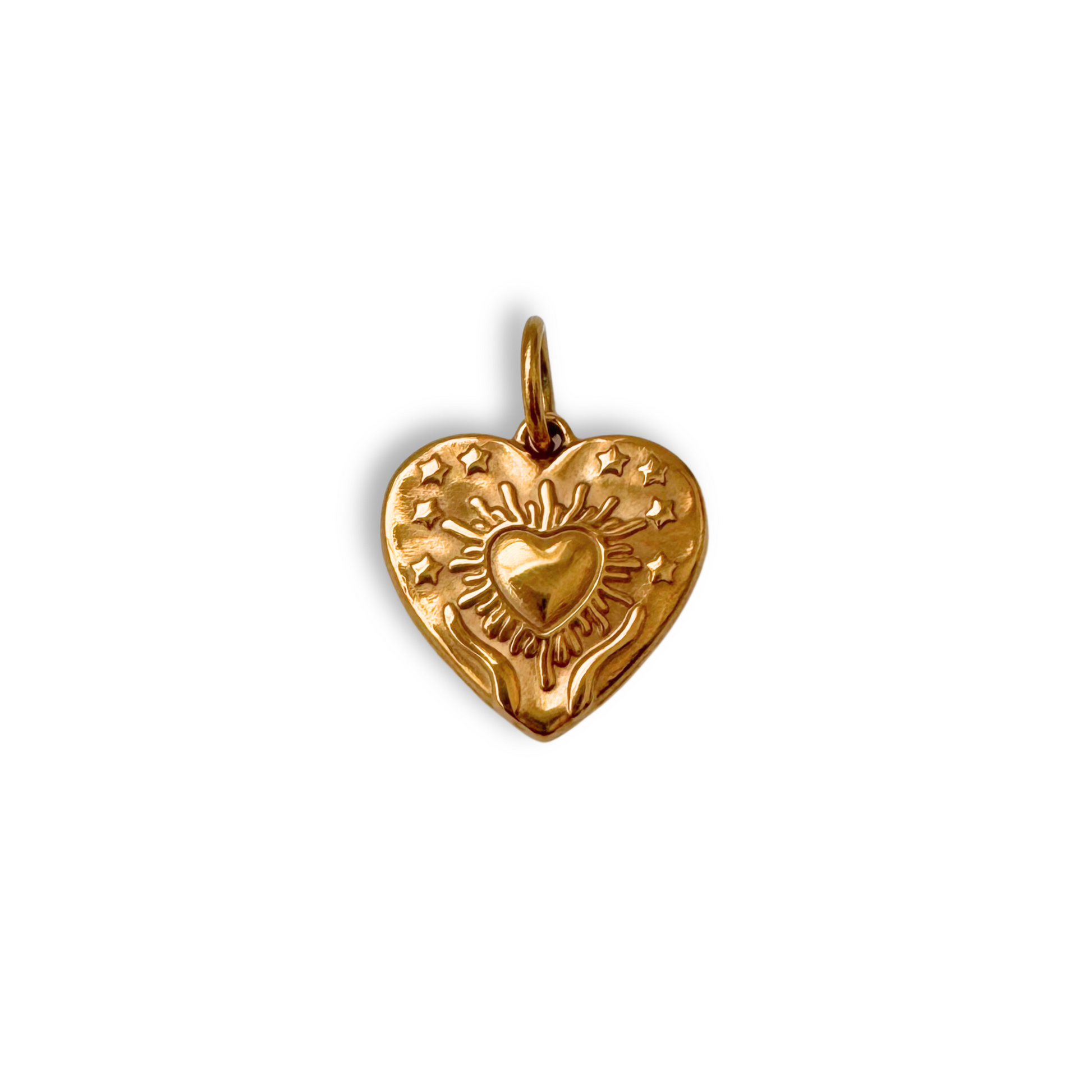 Gold heart-shaped pendant with engraved design on a white background