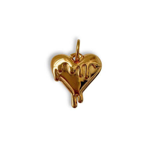 Gold heart-shaped pendant with dripping effect on a white background