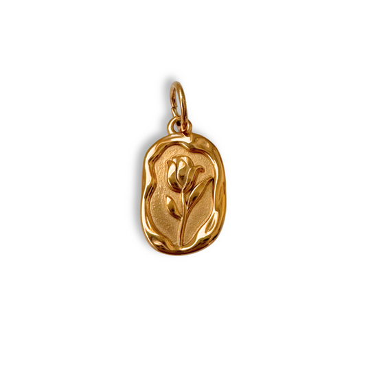 Gold pendant with a rose design on a white background
