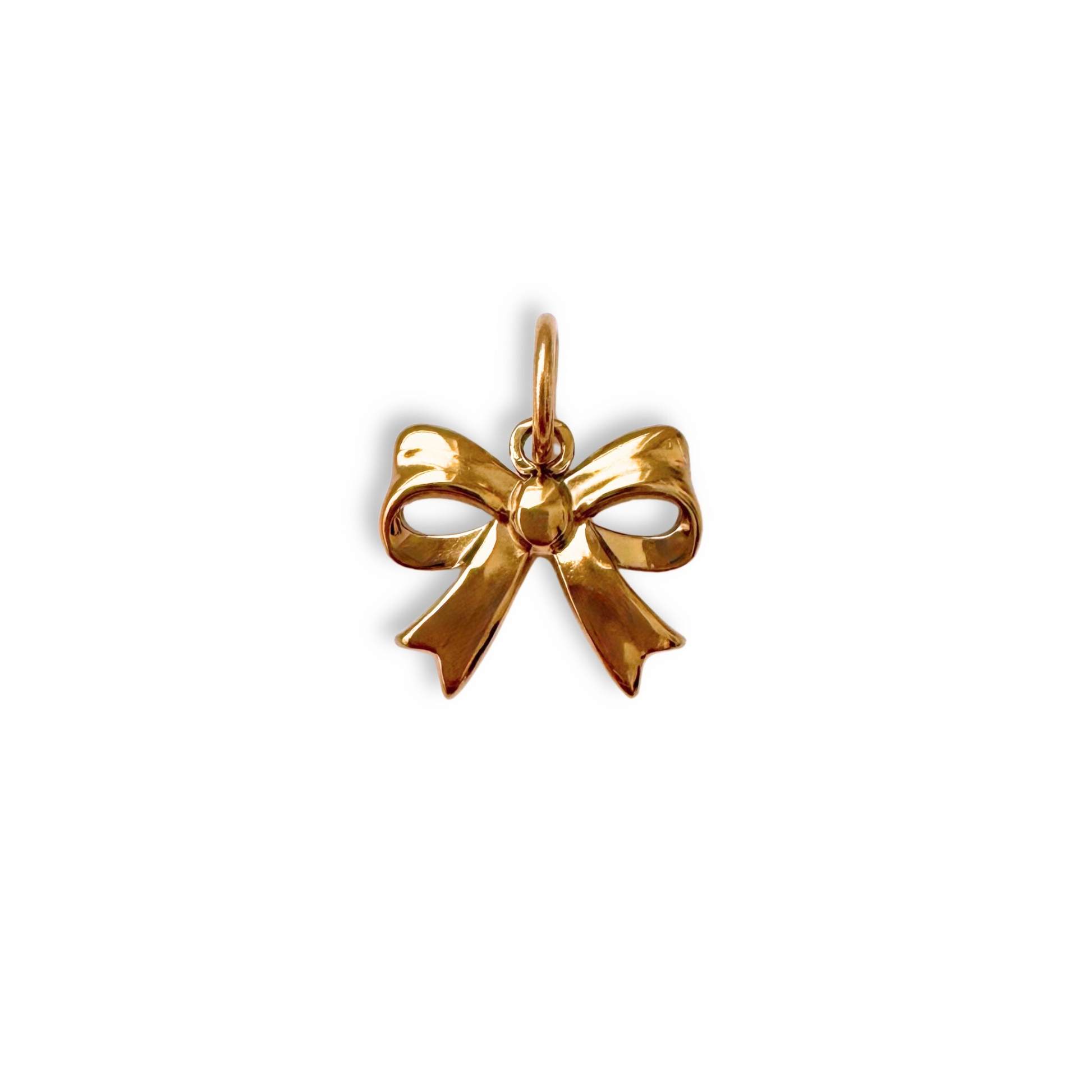 Gold bow-shaped pendant on a white background