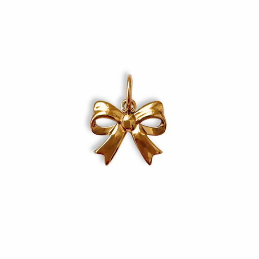 Gold bow-shaped pendant on a white background