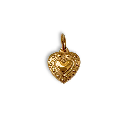 Gold heart-shaped pendant on a white background