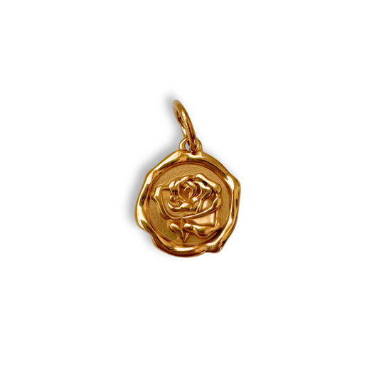 Gold rose-shaped pendant on a white background