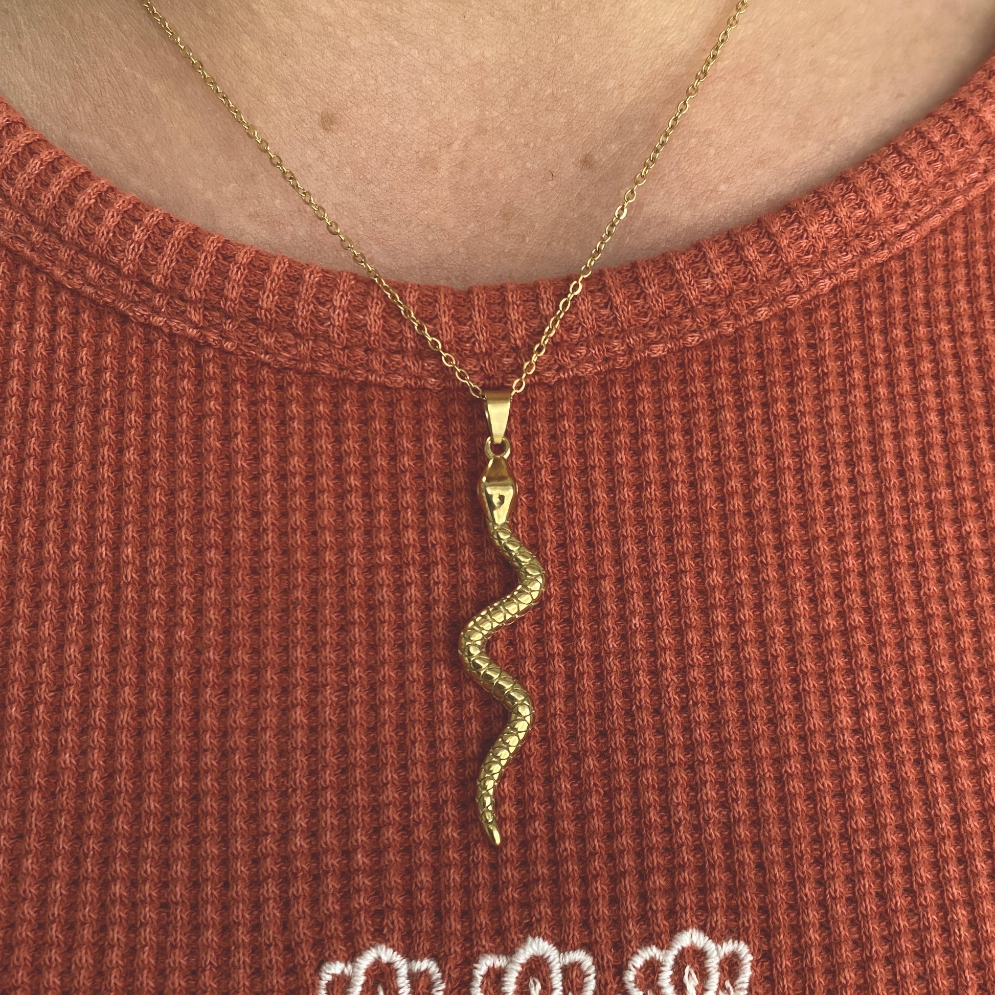 gold snake pendant on gold chain